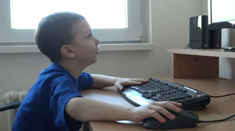 Young child boy works on computer on the table in room  Stock Footage 60747554
