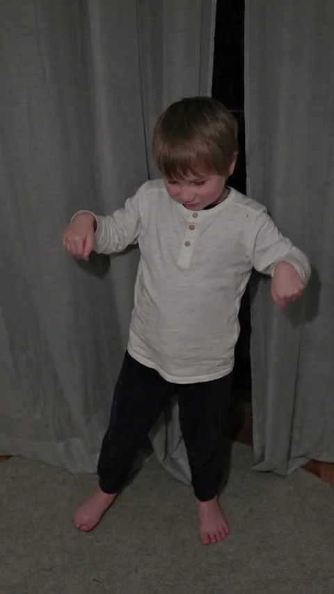 Young child dancing and playing with cat in bedroom Stock Footage 327042774
