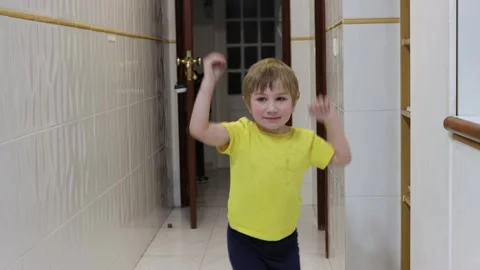 Young child dancing energetically in corridor Stock Footage 316166626
