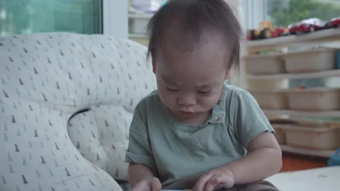 Young Child Engaged in Playtime Activity Vidéo 343556737