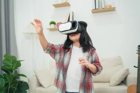 Young Child Engaged in Virtual Reality Experience at Home with Excitement a.. Stock Photos