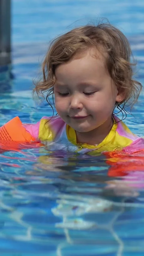 Young Child Enjoys Pool Activity. Little One Practicing Swimming Amidst Cheerful 스톡 동영상 333441259
