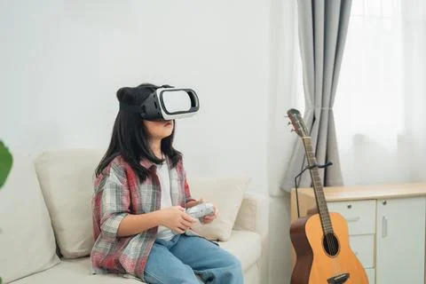 Young child experiencing virtual reality in modern living room, wearing VR .. Fotos Stock