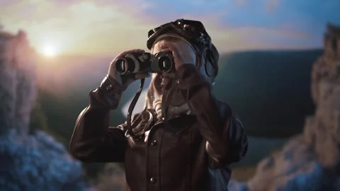 Young child explorer scans mountain view with vintage binoculars. Stock Footage 312439805