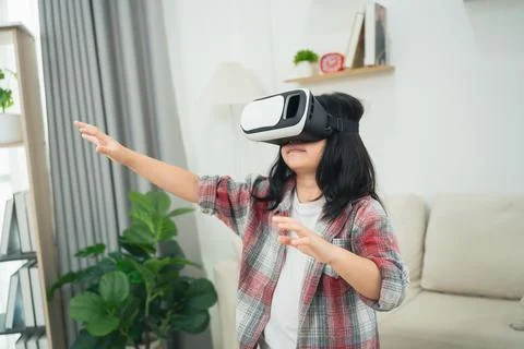 Young child explores virtual reality experience indoors with excitement and.. Stock Photos