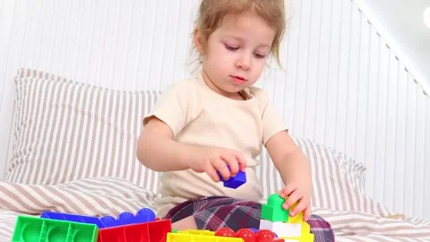 Young child exploring creativity with colorful building blocks at home 스톡 동영상 295351456