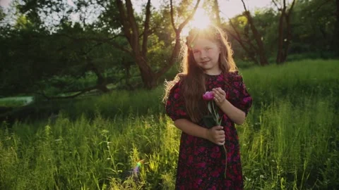 Young child in field with flowers Stock Footage 166174864