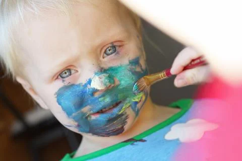Young child getting face painted Stock Photos