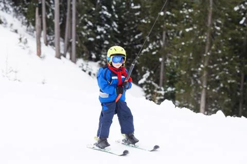 Young child, going up a hill with a surface lift, standing on the ground Stock Photos