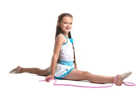Young child gymnast doing split with skipping rope Stock Photos