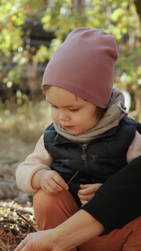A young child happily exploring and experiencing the beauty of nature during the Stock Footage 307681730