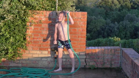 Young child has fun dancing in the shower Stock Footage 139199344