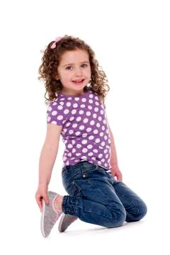 Young child knelt smiling at the camera Stock Photos