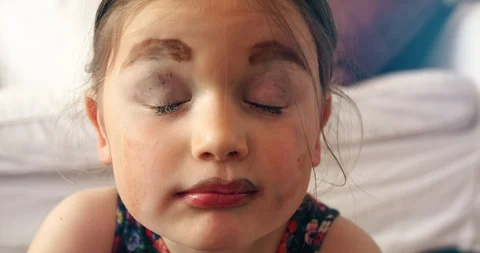 Young child looking at the camera and smiling with funny makeup Video stock 107773389