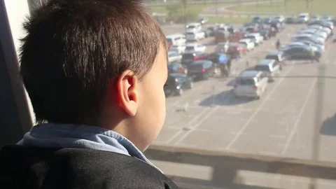 Young child looking out of window of moving train Stock Footage 81670650