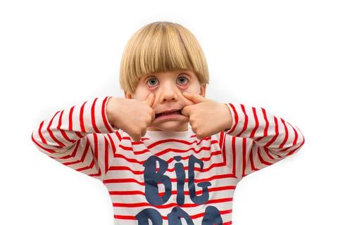 Young Child Making Funny Expression While Pulling Their Face Playfully Stock Photos