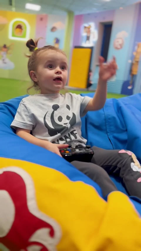 Young Child Playing Console Game with Controller at Home Видео 331748083