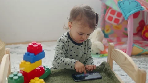 Young child playing with mobile phone. Stock Footage 236242539