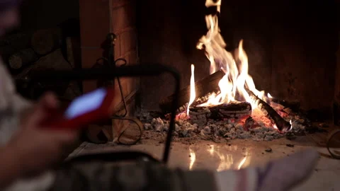 Young child is playing a red video game in front of fireplace. Blurred subject Stock Footage 145964897