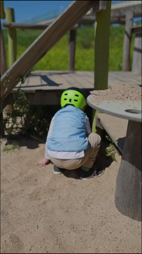 Young child playing with sand at playground Stock Footage 309910963