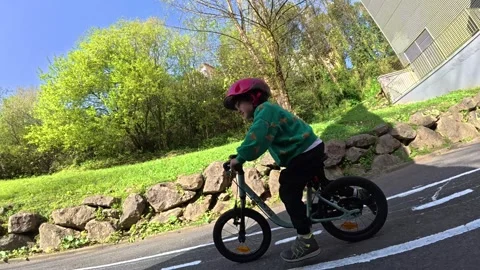 Young child practices cycling in traffic garden Stock Footage 306223879