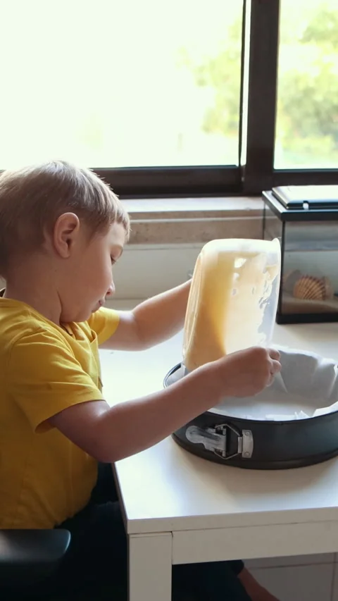 Young child preparing cake batter in kitchen Stock Footage 327132016