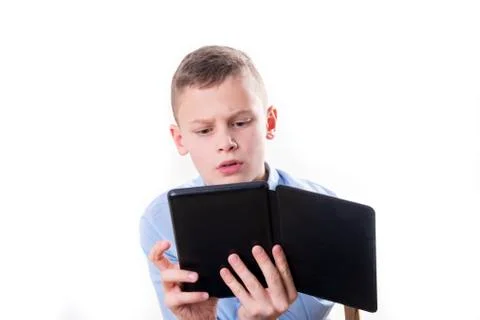 Young child reading strained in an e book reader on white background Stock Photos