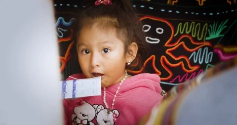 Young child shy looking in camera at indigenous market Stock Footage 86363107