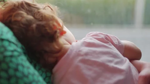 A young child sleeping peacefully in a car seat during a car ride, capturin.. Stockbeeldmateriaal 282979611