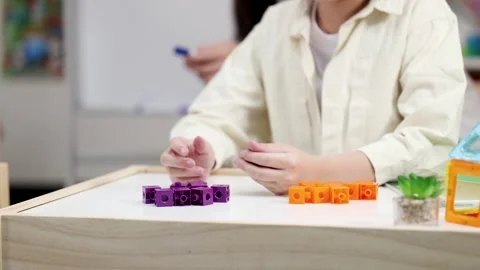 Young Child Sorting Colorful Math Blocks in a Montessori Classroom Setting Stock Footage 327196687