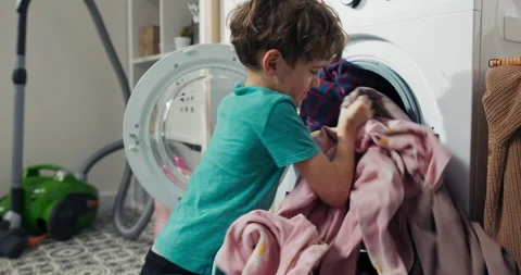 Young child spends time in laundry room, bathroom, performs household chores Stock Footage 201258786