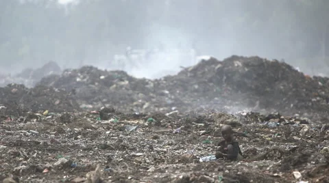 Young child on steaming waste tip Stock Footage 49367892