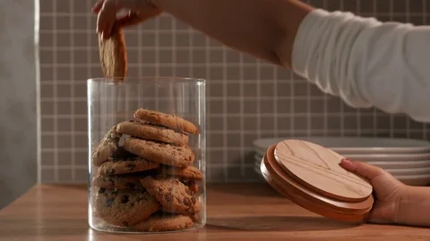 Young child takes a cookie from a cookie jar Stock-Footage 75817152