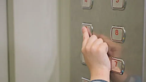 Young child taps elevator panel. Kid presses buttons as mother observes nearby 스톡 동영상 331951505