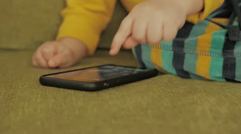 Young child touching mobile cell phone with finger Stock-Footage 54028424