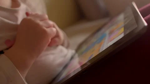 A young child using a tablet shows a modern way of engaging in play and learning Stock-Footage 297202034