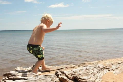 Young Child Walking on Beach Stock Photos