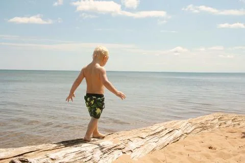 Young Child Walking on Beach Stock Photos