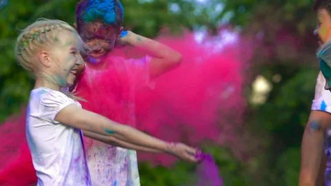 Young children having fun and throwing colorful holy powder at each other Stock-Footage 70872558