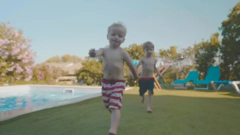 Young children play by the side of a poo... | Stock Video | Pond5