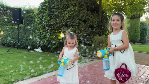Young Children Playfully Creating Bubbles at Outdoor Wedding Party Celebration Stock Footage 346303848