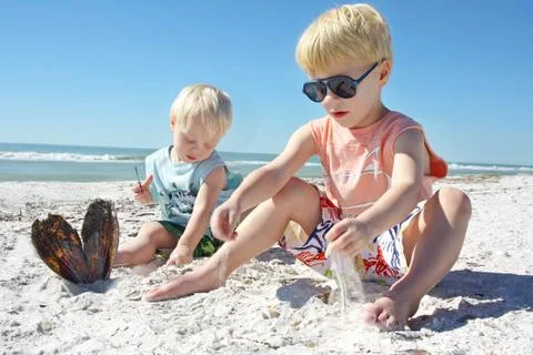 Young children playing in the sand at the beach Stock Photos
