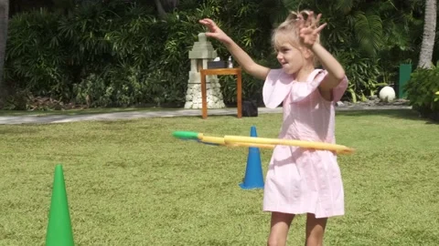 Young children sisters having fun with hula hoop outside in the park Stock Footage 139401271