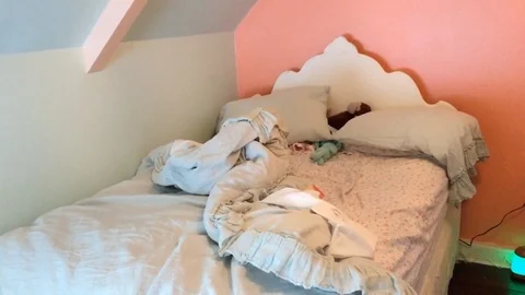 Young child's bed left messy in bedroom of house Stock Footage 85740240