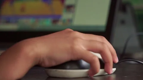Young child’s hand on a computer mouse, concept of education technology, Stock Footage 327614196