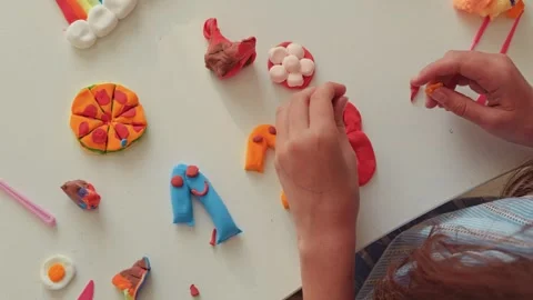 Young Child's Hands Engaged in Creative Play with Colorful Modeling Clay, Stockbeeldmateriaal 336464476