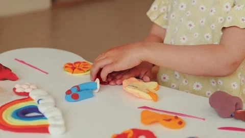 Young Child's Hands Engaged in Creative Play with Colorful Modeling Clay and 動画素材 336464486