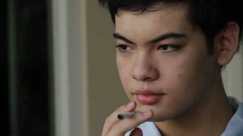 Young Chinese boy smokes to camera Stock Footage 40499039