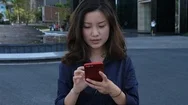Young Chinese Businesswoman Using Smartphone Walking In The City, Slow Motion,4K Stock Footage