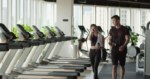 Young Chinese couple taking a break from workout at gym,4K Stock Footage 155421953